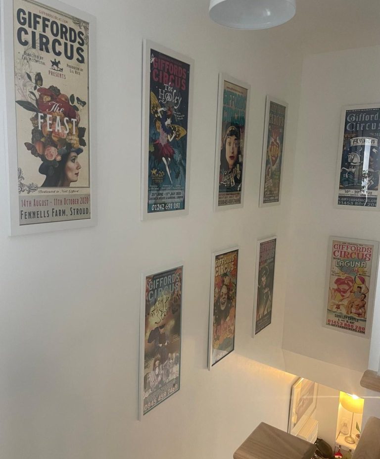 Property Maintenance Services An interior staircase in a new build property with framed Circus posters hung on the wall.